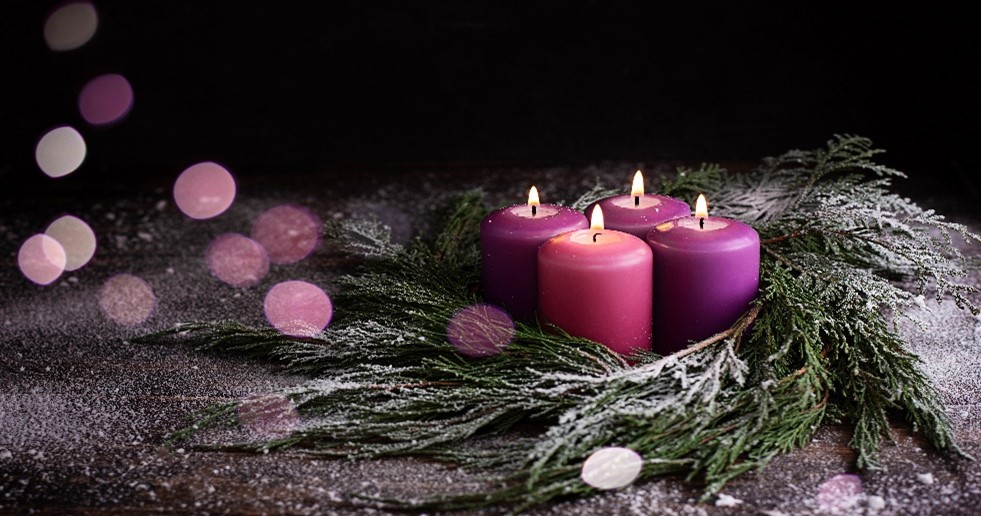 Purple candles wrapped with pine wreath