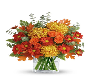 A bouquet of flowers in a glass vase

Description automatically generated